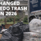 Bulk trash and wrapped furniture set at a Toledo curb with a Republic Services garbage truck during 2026 trash pickup changes
