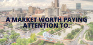 Aerial view of downtown Toledo along the riverfront highlighting neighborhoods, bridges, and ongoing urban growth.