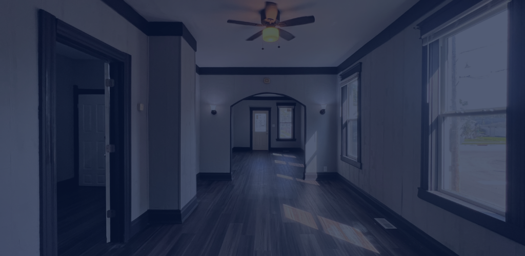 Clean, empty rental property interior with hardwood flooring and natural light.