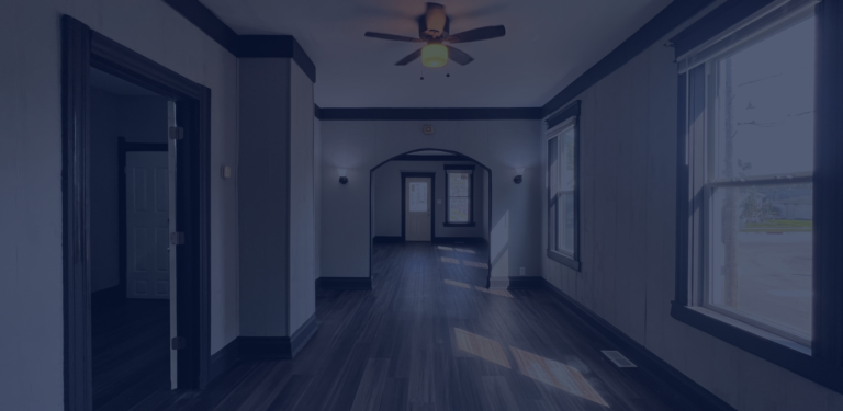 Clean, empty rental property interior with hardwood flooring and natural light.